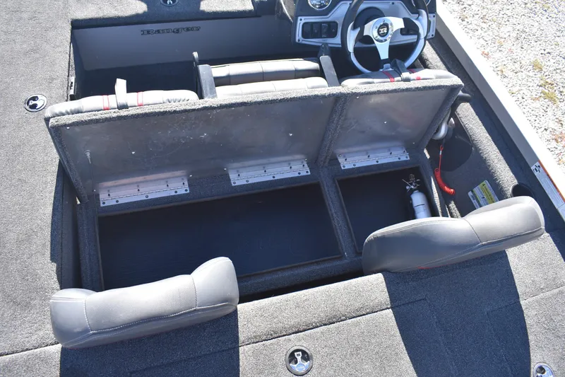 Slide: The Image of 2015 Ranger RT178C boat interior with open storage compartments and steering wheel. - 17