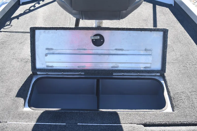 Slide: The Image of 2015 Ranger RT178C boat storage compartment with open lid, showcasing interior space. - 18
