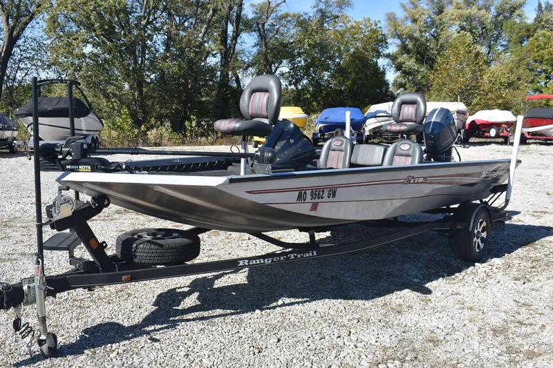 Slide: The Image of 2015 Ranger RT178C fishing boat on trailer, parked outdoors with trees in background. - 6