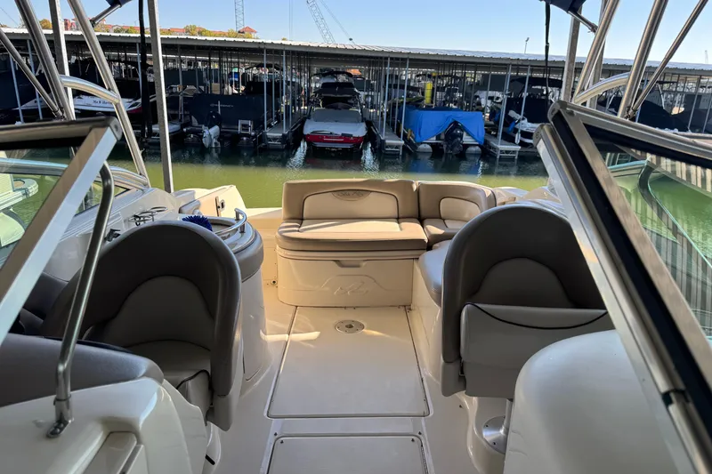 Slide: The Image of 2004 Sea Ray 270 Sundeck interior with seating, docked at marina. - 5