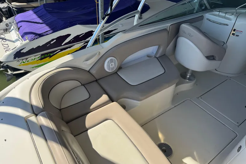 Slide: The Image of 2004 Sea Ray 270 Sundeck interior with beige seating and helm chair. - 7