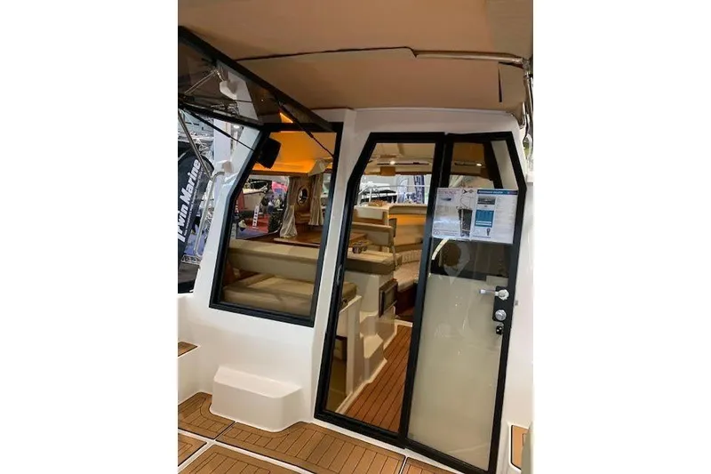Slide: The Image of 2022 Ranger Tugs R-25 boat interior with modern design and wooden flooring. - 12