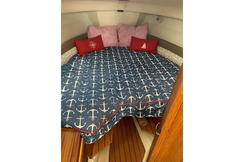 Slide: The Image of Cozy cabin interior of 2022 Ranger Tugs R-25 with nautical-themed bedding. - 27