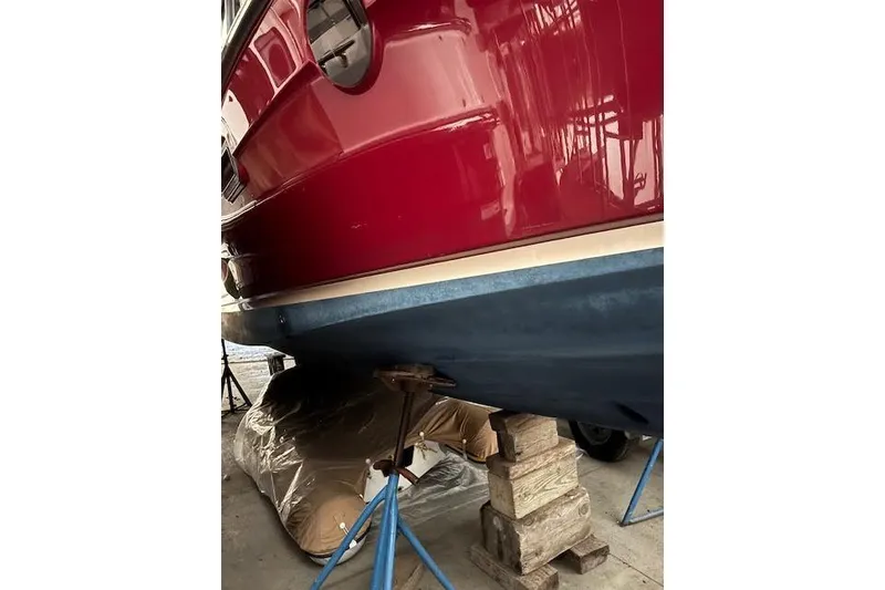 Slide: The Image of 2022 Ranger Tugs R-25 boat hull in dry dock, supported by stands. - 31