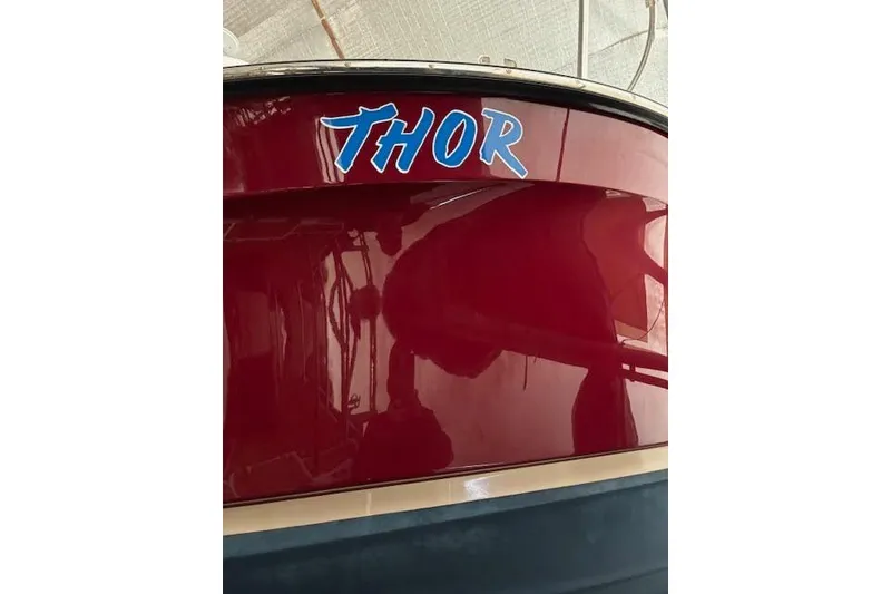 Slide: The Image of Red 2022 Ranger Tugs R-25 boat with "Thor" name on the stern. - 32