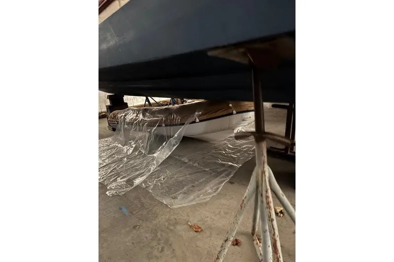 Slide: The Image of 2022 Ranger Tugs R-25 boat under maintenance with protective plastic covering. - 34