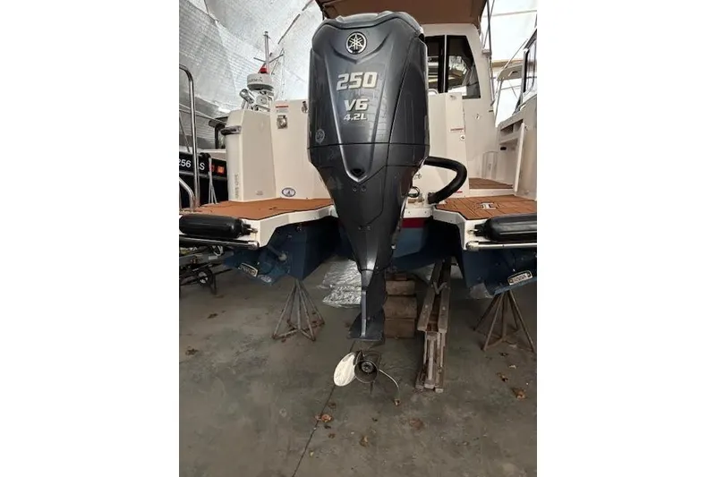 Slide: The Image of 2022 Ranger Tugs R-25 with Yamaha 250 V6 outboard motor in a storage facility. - 35