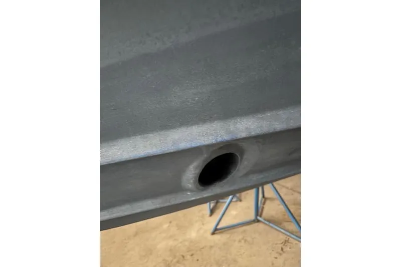 Slide: The Image of Close-up of a 2022 Ranger Tugs R-25 hull with a visible drain hole. - 36