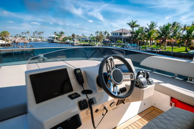 Slide: The Image of Absolute 48 Navetta 2020 yacht on serene waterway with clear blue sky. - 16