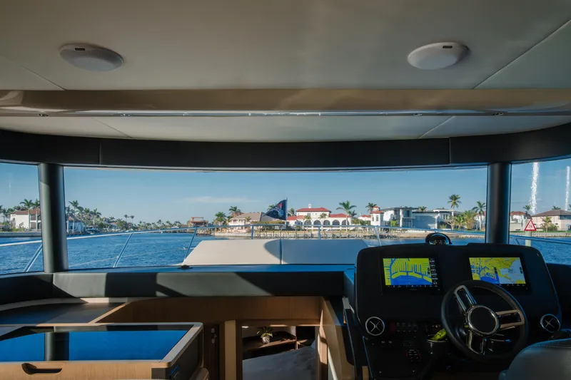 Slide: The Image of Flybridge of 2020 Absolute 48 Navetta yacht with scenic waterfront view. - 23