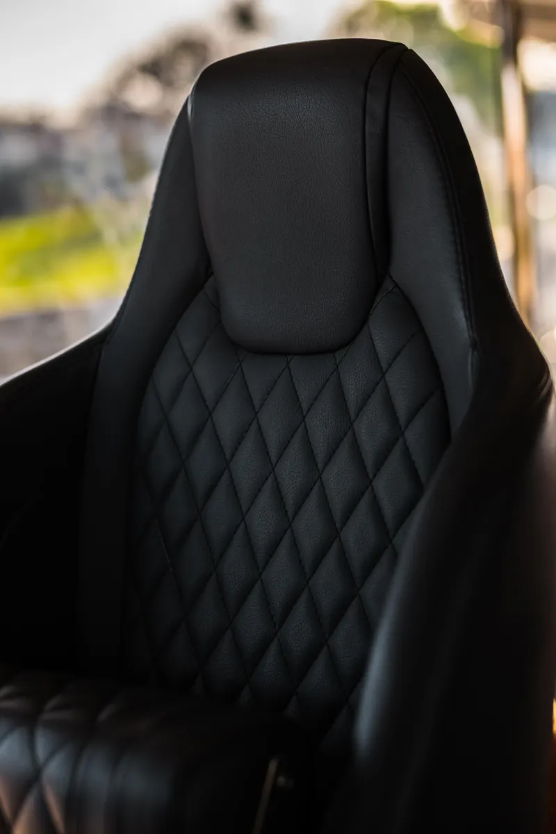 Slide: The Image of Wooden table on Absolute 48 Navetta yacht, 2020 model, with woven chair beneath. - 27