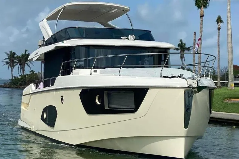 Slide: The Image of Luxury Absolute NAVETTA 48 yacht from 2020 cruising near palm trees and blue skies. - 4