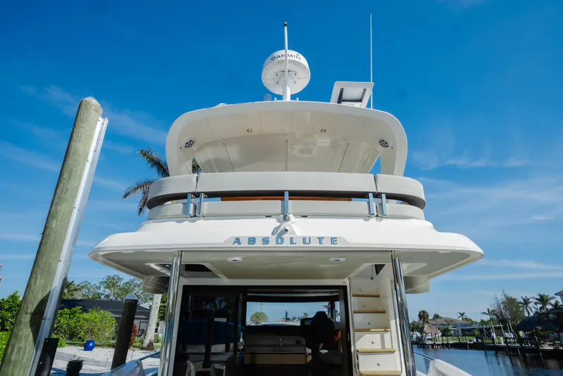 Slide: The Image of Luxury Absolute NAVETTA 48 yacht docked, 2020 model, under clear blue sky. - 6