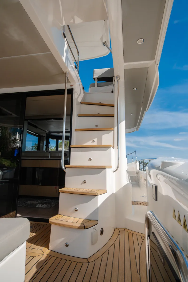 Slide: The Image of Luxury Absolute NAVETTA 48 yacht docked by a scenic waterfront, 2020 model. - 9