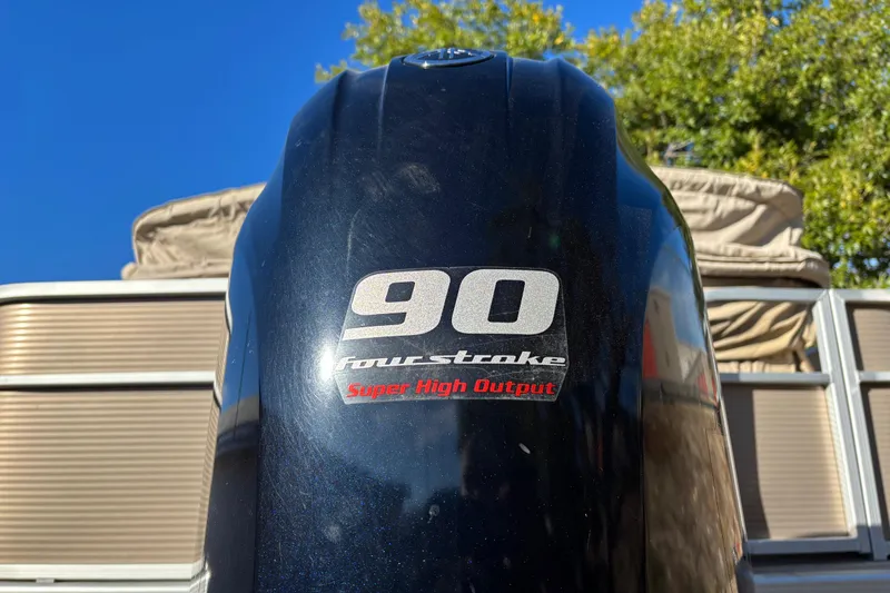 Slide: The Image of Close-up of 2020 Bennington 21SF boat logo on black surface. - 10