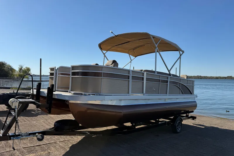 Slide: The Image of 2020 Bennington 21SF boat seat with beige upholstery and measuring ruler detail. - 102