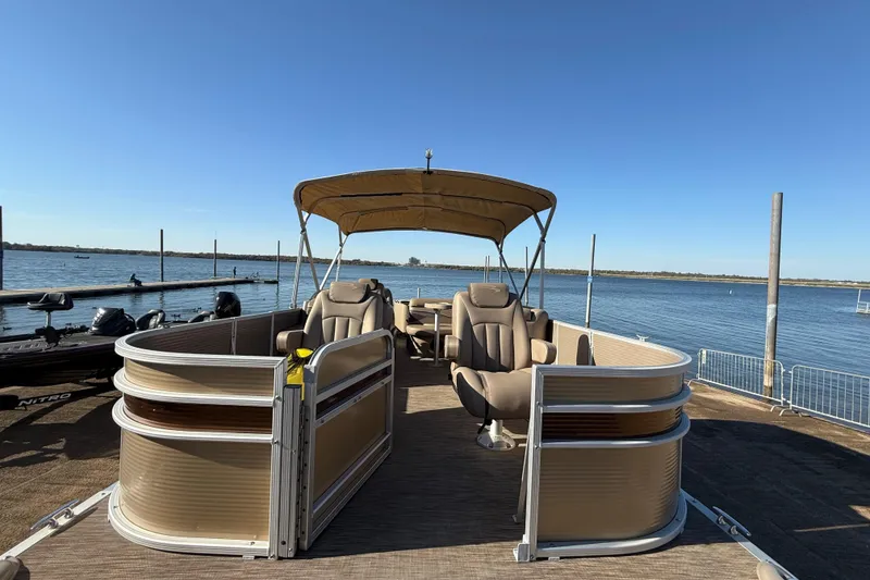 Slide: The Image of 2020 Bennington 21SF pontoon boat on trailer by a lake under clear blue sky. - 111
