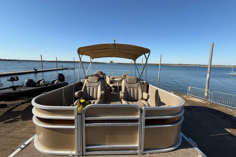 Slide: The Image of 2020 Bennington 21SF pontoon boat docked by a serene lake under clear blue skies. - 112