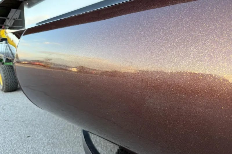 Slide: The Image of 2020 Bennington 21SF pontoon boat on trailer, showcasing sleek design and metallic finish. - 15