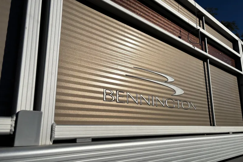 Slide: The Image of 2020 Bennington 21SF pontoon boat on trailer, featuring a canopy and sleek design. - 2