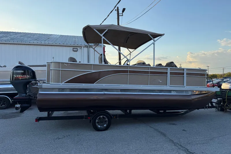 Slide: The Image of 2020 Bennington 21SF pontoon boat with Yamaha VMAX engine on trailer. - 21