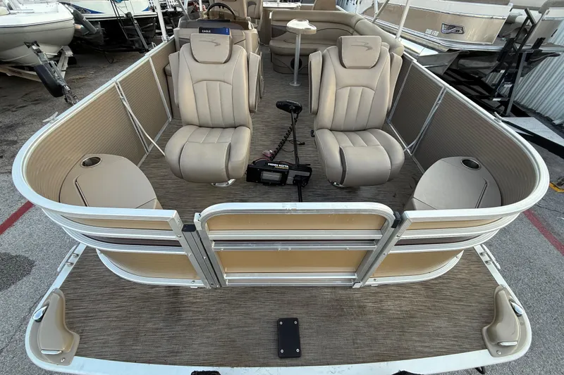 Slide: The Image of 2020 Bennington 21SF pontoon boat on trailer, parked near a building. - 24