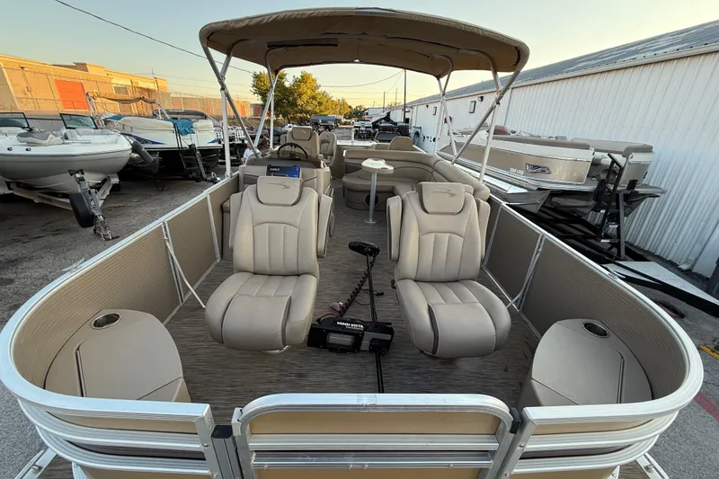 Slide: The Image of 2020 Bennington 21SF pontoon boat interior with beige seating and steering console. - 25