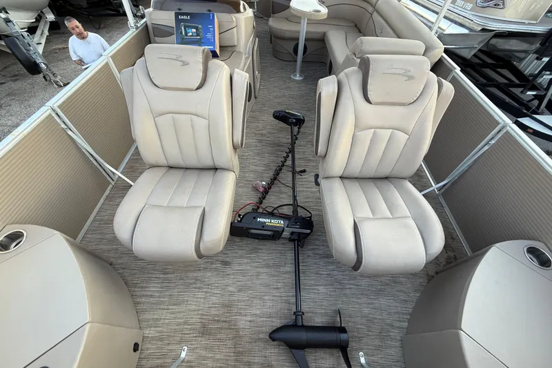 Slide: The Image of 2020 Bennington 21SF pontoon boat with beige seating and canopy, docked in a marina. - 26