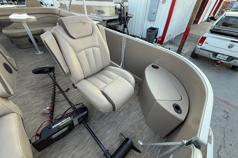 Slide: The Image of 2020 Bennington 21SF pontoon boat interior with beige seating and trolling motor. - 29