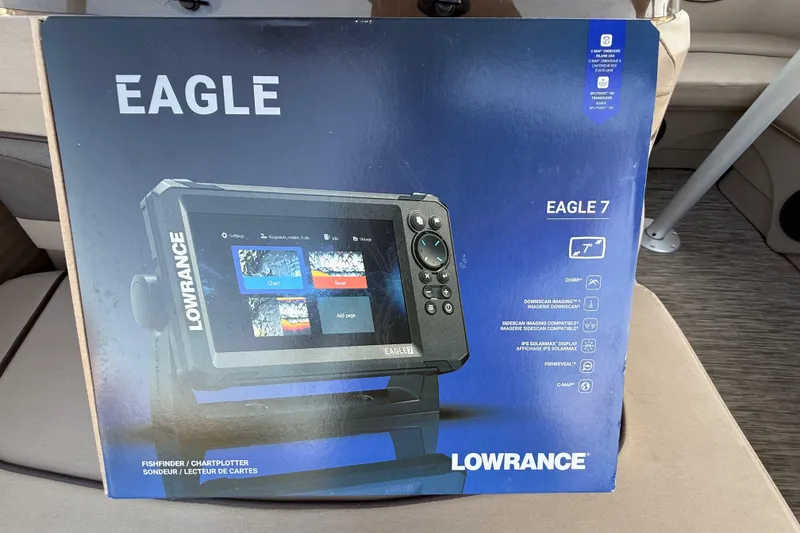 Slide: The Image of 2020 Bennington 21SF pontoon boat interior with seating, parked in a lot. - 35