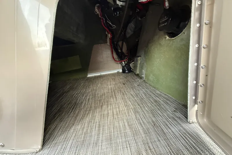 Slide: The Image of 2020 Bennington 21SF boat storage compartment with open hatch and visible interior. - 38