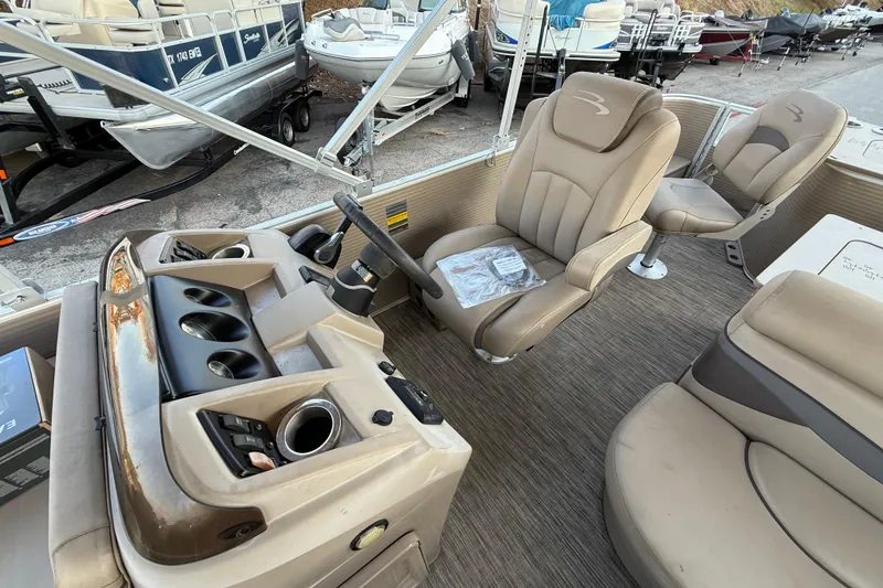 Slide: The Image of 2020 Bennington 21SF pontoon boat interior with beige seating and steering console. - 41