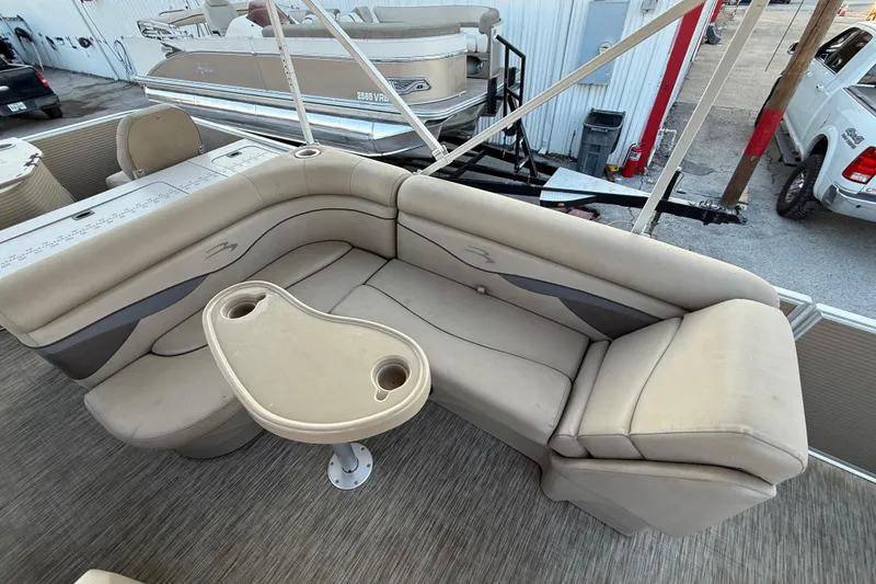 Slide: The Image of 2020 Bennington 21SF pontoon boat interior with beige seating and steering wheel. - 45