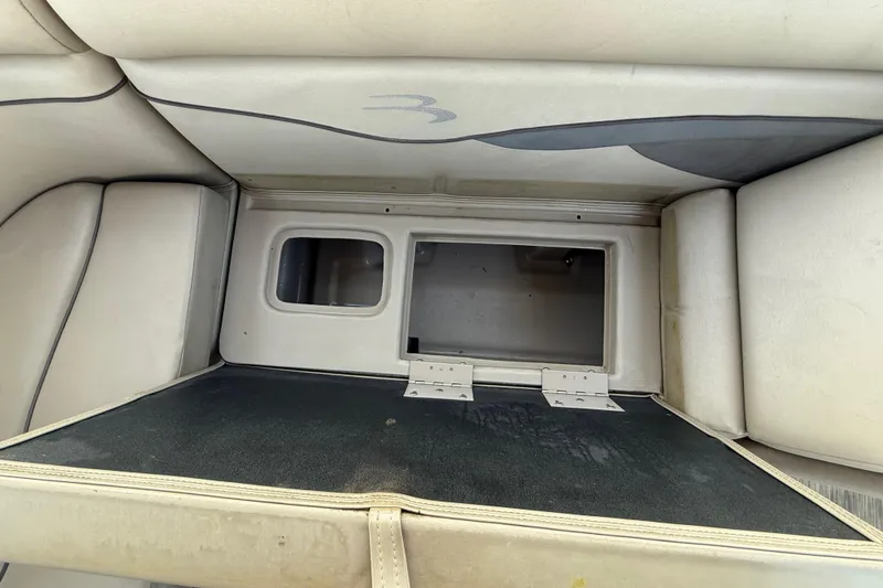 Slide: The Image of 2020 Bennington 21SF boat interior with beige seating and a small table. - 46