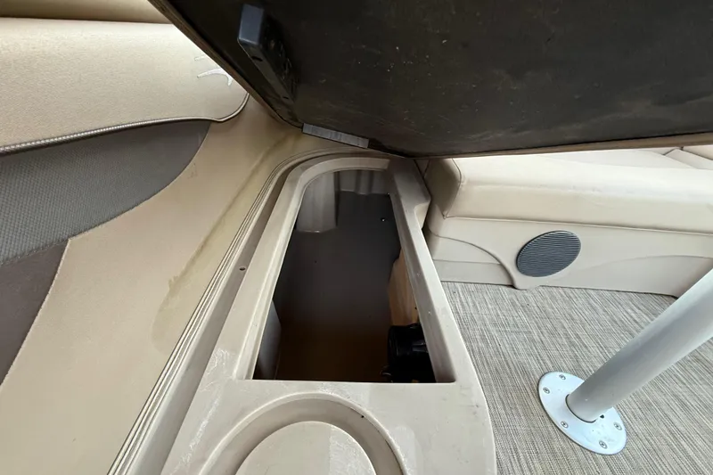 Slide: The Image of Interior storage compartment of a 2020 Bennington 21SF boat, featuring cushioned seating. - 47