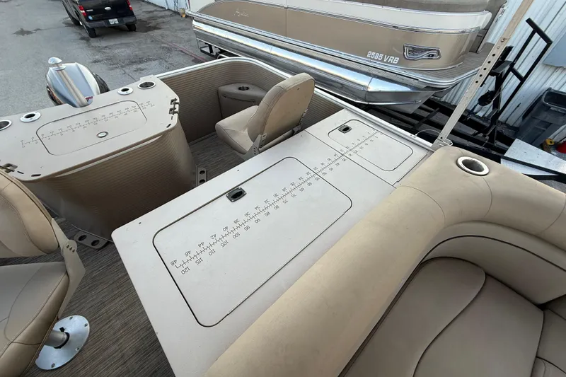 Slide: The Image of Open storage compartment in 2020 Bennington 21SF boat, featuring beige interior and speaker. - 48