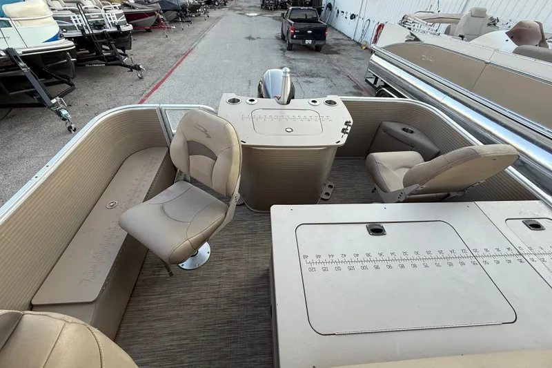 Slide: The Image of 2020 Bennington 21SF pontoon boat interior with beige seating and fishing station. - 49