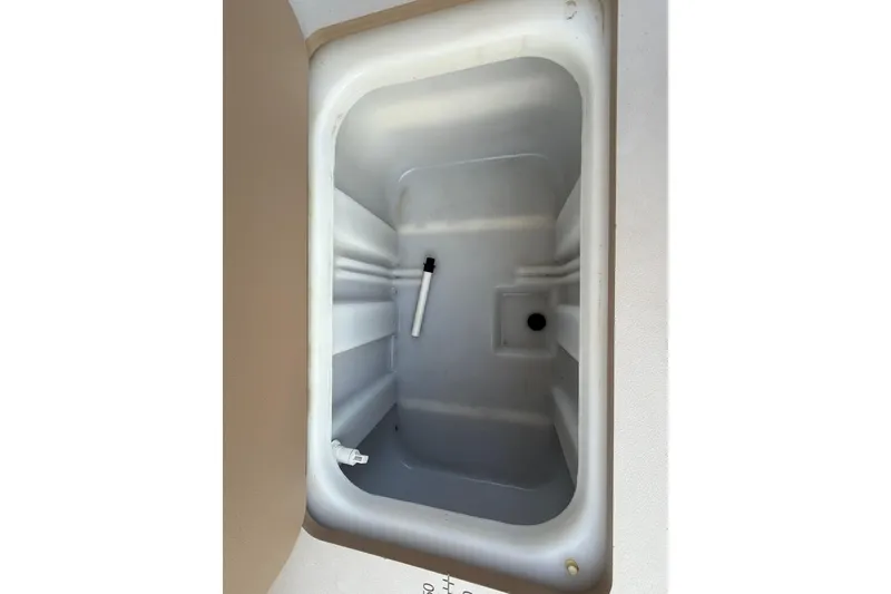 Slide: The Image of 2020 Bennington 21SF boat interior with beige seating and storage compartments. - 56