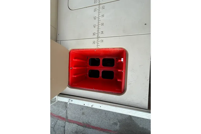 Slide: The Image of Open storage compartment in 2020 Bennington 21SF boat, featuring a white interior. - 57