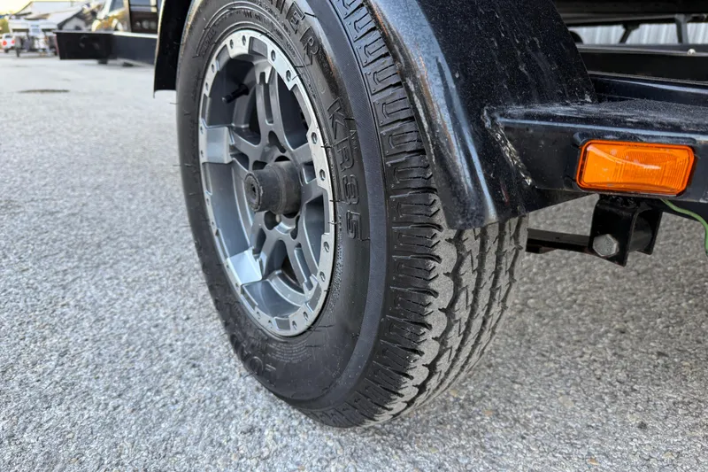 Slide: The Image of Close-up of a 2020 Bennington 21SF wheel with Karrier tire on asphalt. - 68