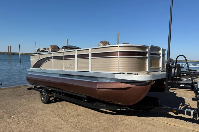 Slide: The Image of 2020 Bennington 21SF pontoon boat on trailer by a lake. - 72
