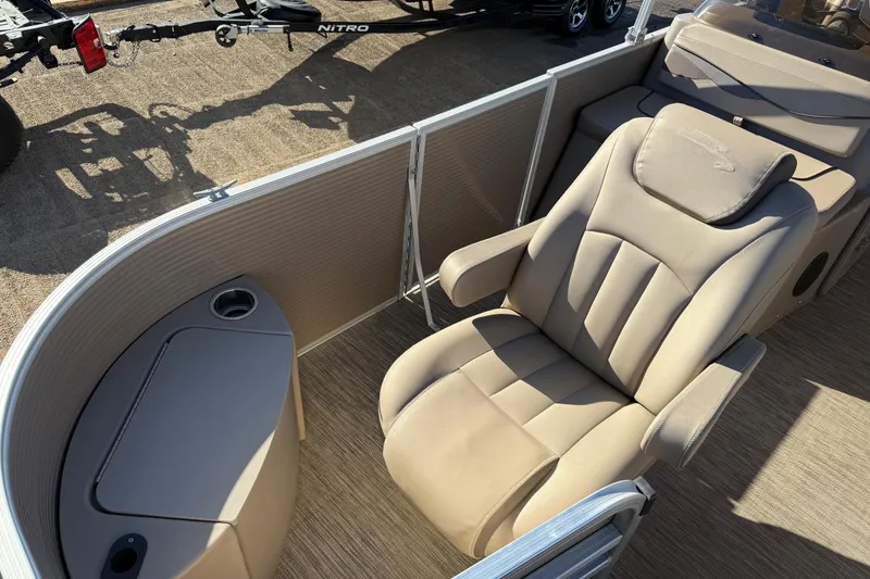 Slide: The Image of 2020 Bennington 21SF pontoon boat by the water, showcasing sleek design and branding. - 88