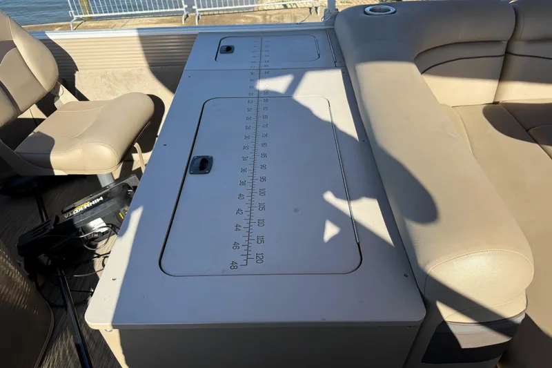 Slide: The Image of 2020 Bennington 21SF boat interior with beige seating by the water. - 99