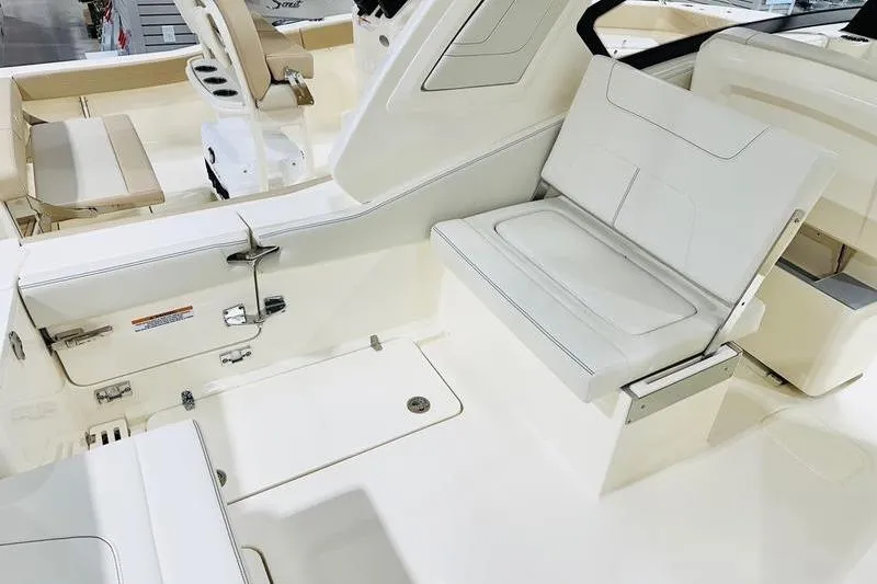 Slide: The Image of 2026 Scout 277 Dorado boat interior with white seating and modern design. - 11
