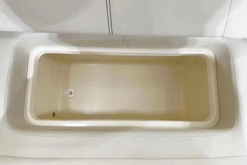Slide: The Image of 2026 Scout 277 Dorado boat storage compartment, beige interior, top view. - 12