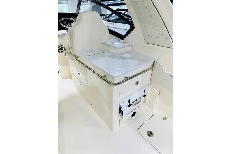 Slide: The Image of 2026 Scout 277 Dorado boat interior with white seating and storage compartments. - 13