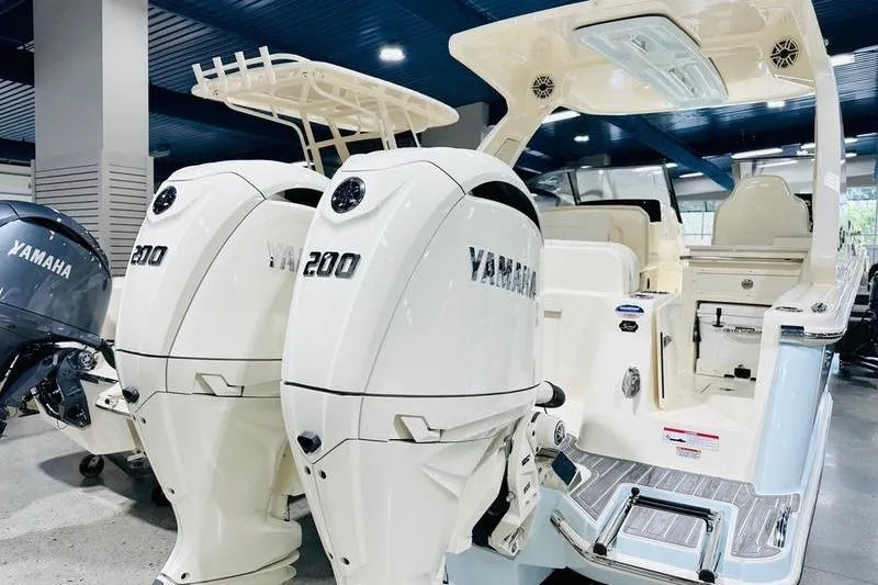 Slide: The Image of 2026 Scout 277 Dorado boat with dual Yamaha 200 engines in showroom. - 15