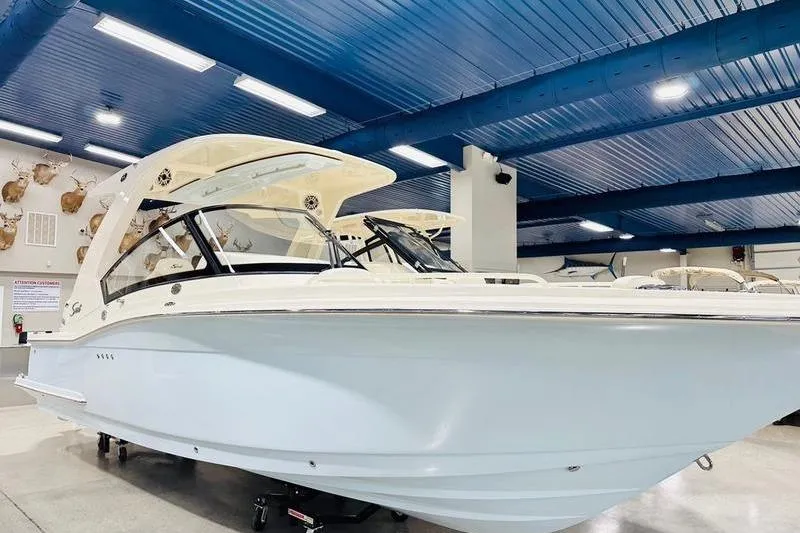 The Image of 2026 Scout 277 Dorado boat displayed indoors under blue ceiling. - 2