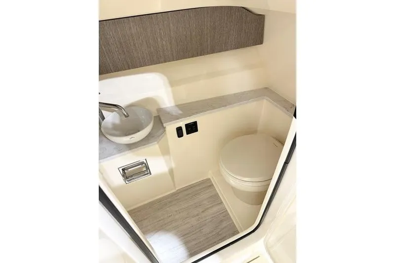 Slide: The Image of 2026 Scout 277 Dorado boat interior bathroom with sink and toilet. - 7