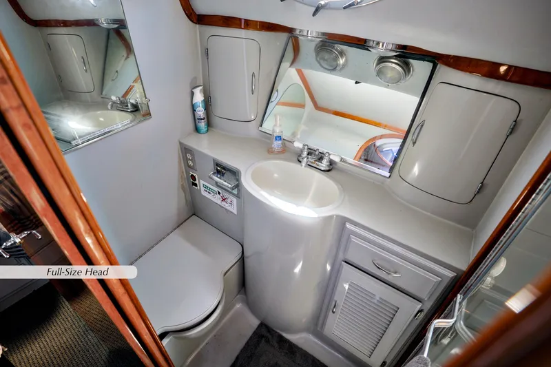 Slide: The Image of 1993 Mediterranean 38 Convertible yacht bathroom with sink, mirror, and storage cabinets. - 12